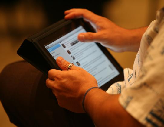 Person scrolling on an ipad