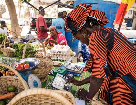 Woman in a market using a mobile device