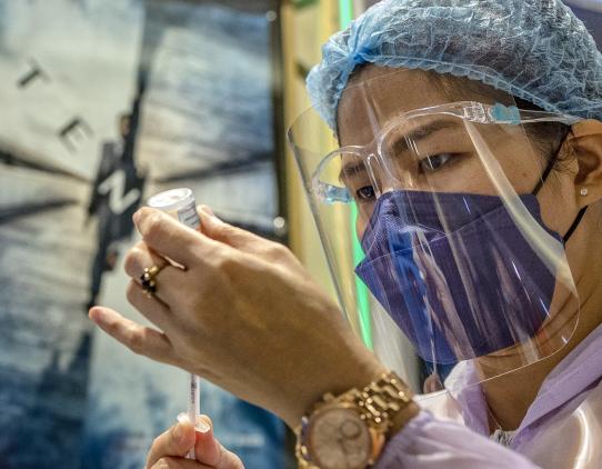 A nurse prepares a covid vaccine dose