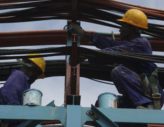 Construction workers working on beams