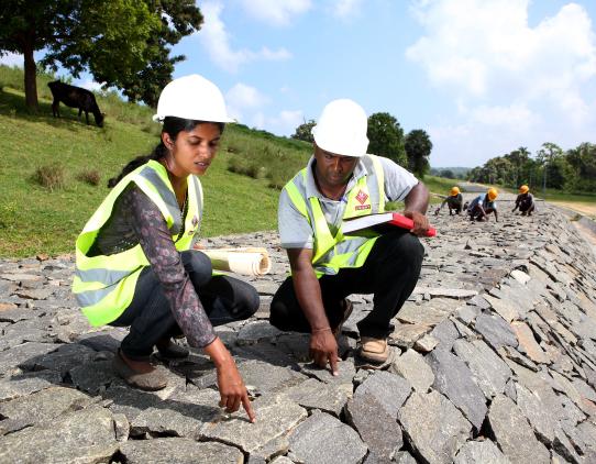Male and female construction workers Male and female construction workers