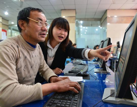 Man and woman working on a computer