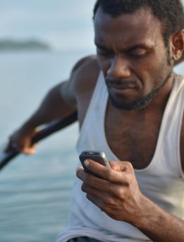 Man using a mobile phone on a boat